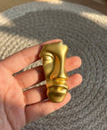 gold half face brooch
