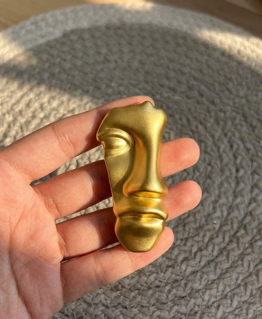 gold half face brooch