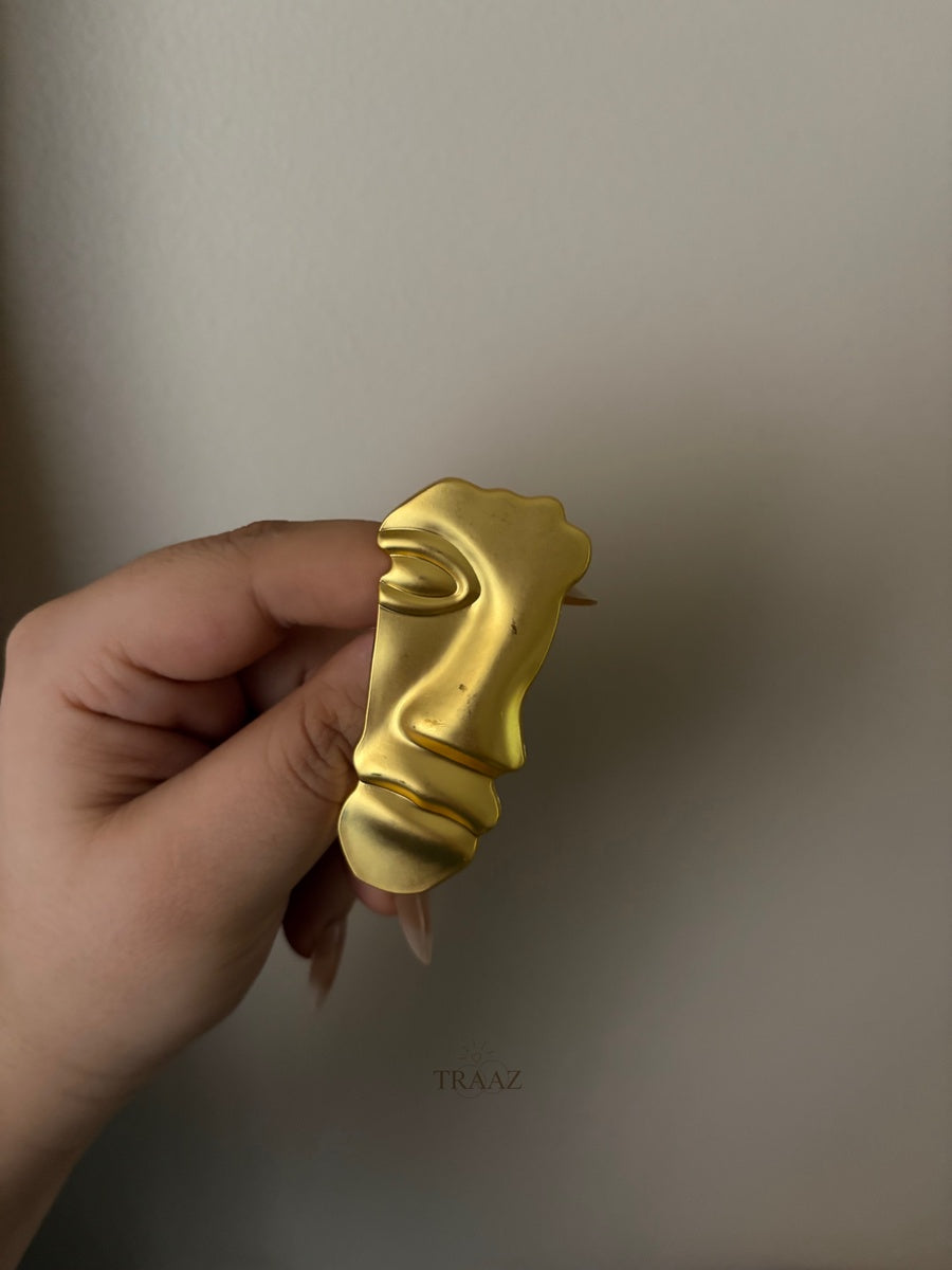 gold half face brooch