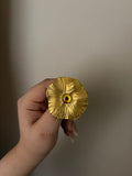 yellow eye gold brooch