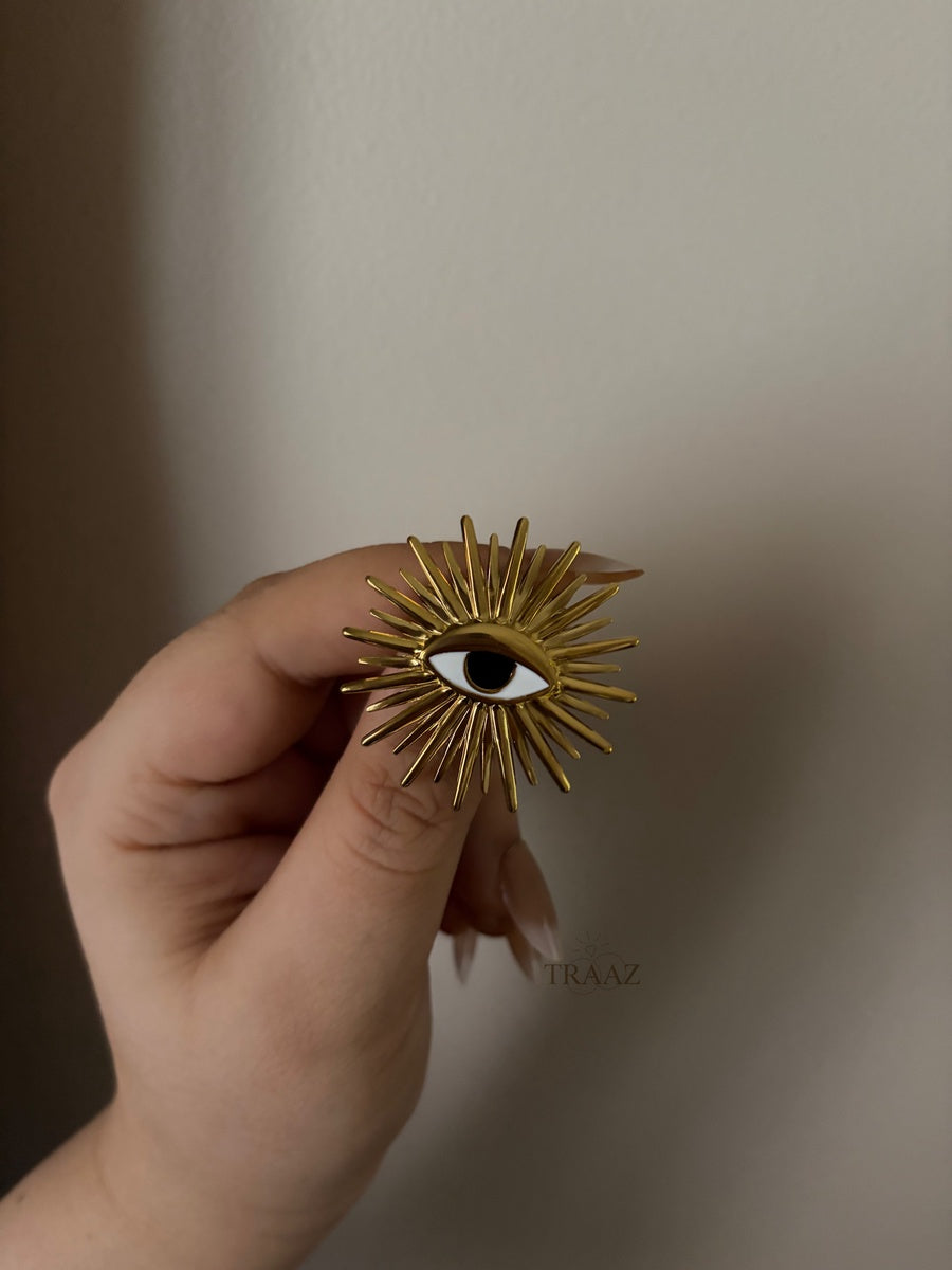 Gold eye brooch